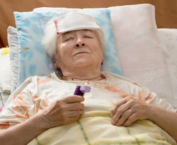 Senior woman lying at bed — Stock Photo, Image