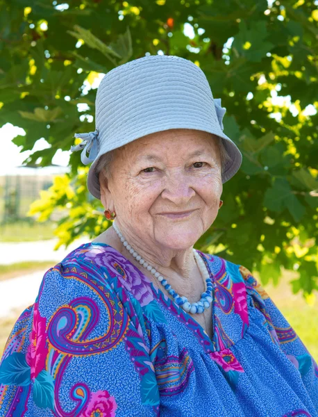 Portrét smějící se stará žena v klobouku — Stock fotografie