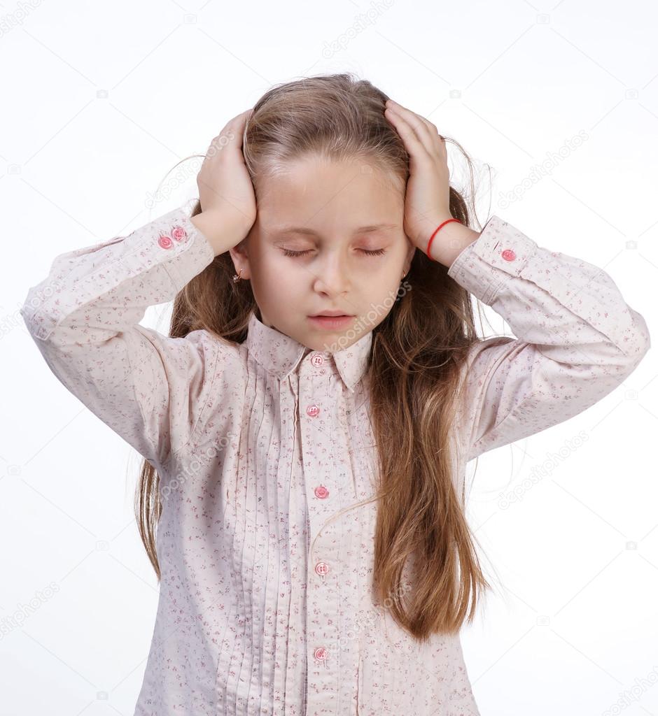 Little girl suffering from headache