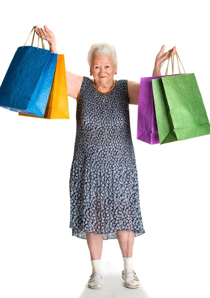 Happy old woman with shopping bags — Stock Photo, Image