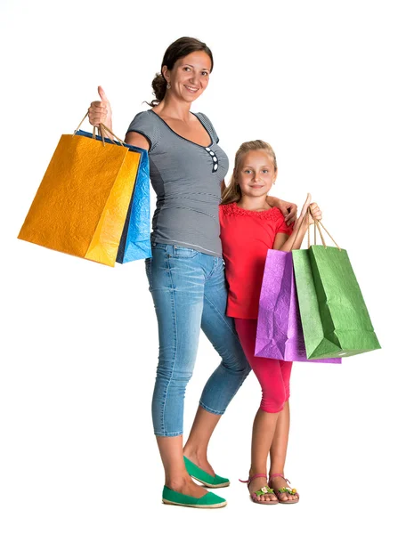 Sonriente madre e hija con bolsas de compras —  Fotos de Stock
