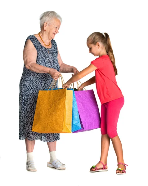 Sonriente abuela con nieta con bolsas de compras — Foto de Stock