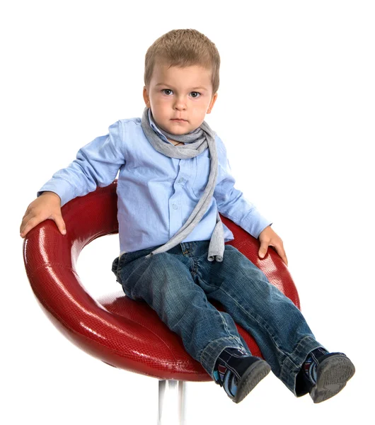 Sad boy sitting on a chair — Stock Photo, Image