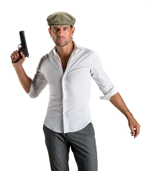 Handsome man in cap with a gun — Stock Photo, Image