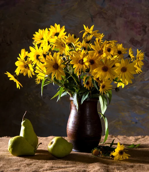 Bunch of yellow flowers (rudbeckia) in brown vase and pears — Stock Photo, Image
