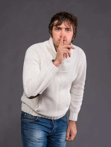 Handsome man with finger on lips asking for silence — Stock Photo, Image