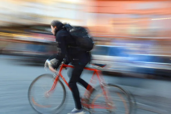Cyclist in motion going down the street — Stock Photo, Image
