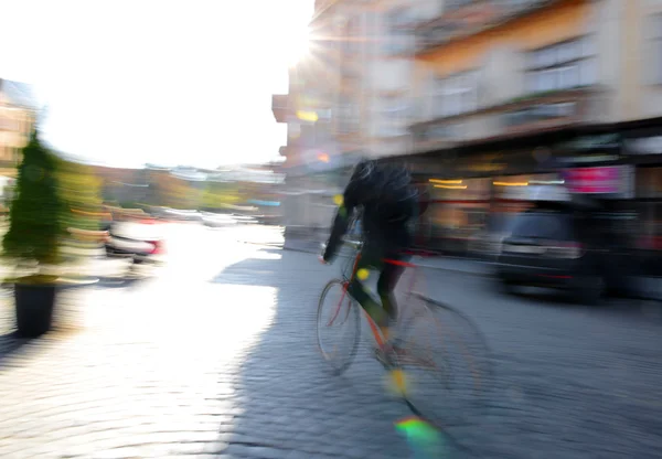 Cyclist in motion going down the street — Stock Photo, Image