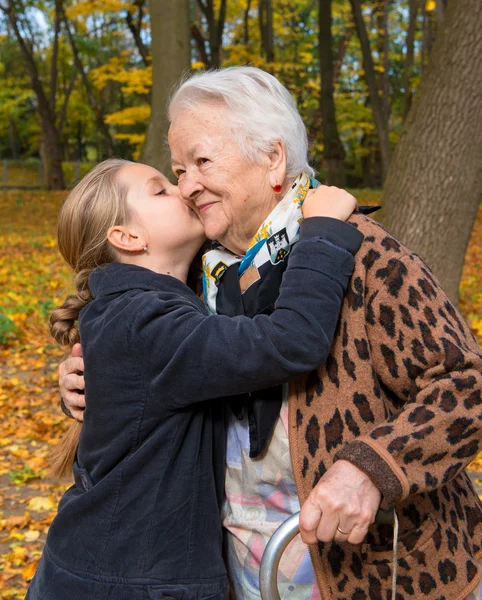 Granddaughter kissing her grandmother — Stock Photo, Image