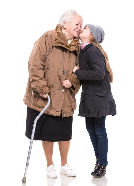 Granddaughter kissing her grandmother — Stock Photo, Image