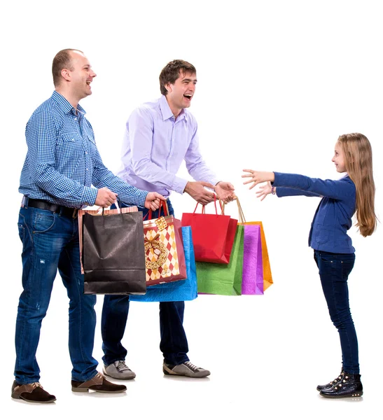Two men giving shopping bags to a girl — Stock Photo, Image