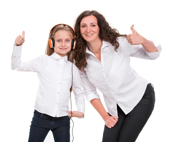 Little girl in headphones listening to music and mother — Stock Photo, Image