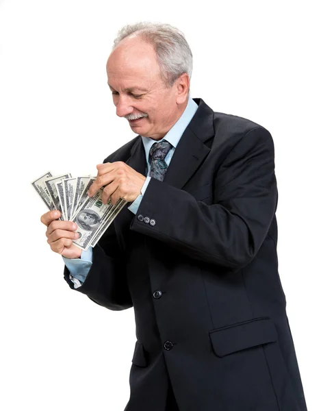 Senior Geschäftsmann hält Gruppe von Dollar — Stockfoto