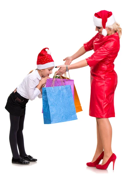 Happy mother and daughter in santa hats — Stock Photo, Image