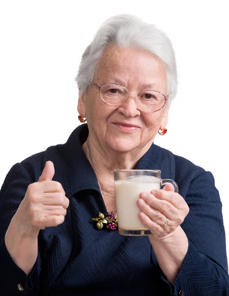 Healthy old woman holding a glass milk — Stock Photo, Image