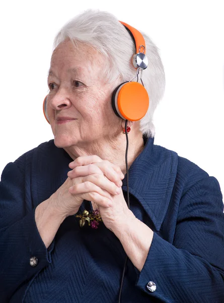 Old woman listening to music in headphones — Stock Photo, Image