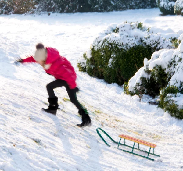 Small girl sledding at winter time — Stock Photo, Image