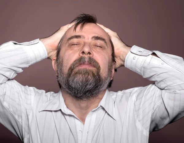 Elderly man suffering from a headache — Stock Photo, Image