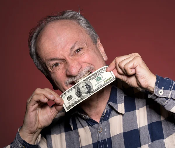 Hombre sosteniendo con placer un billete de cien dólares —  Fotos de Stock