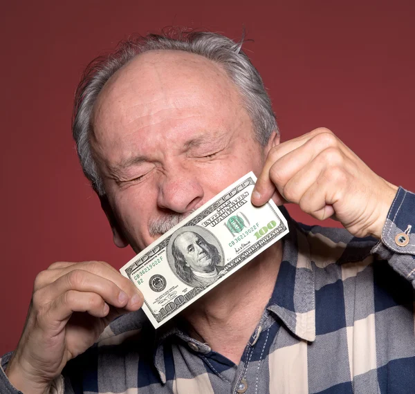 Man holding with pleasure one hundred dollar bill