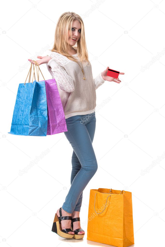 Happy girl with shopping bags and credit card