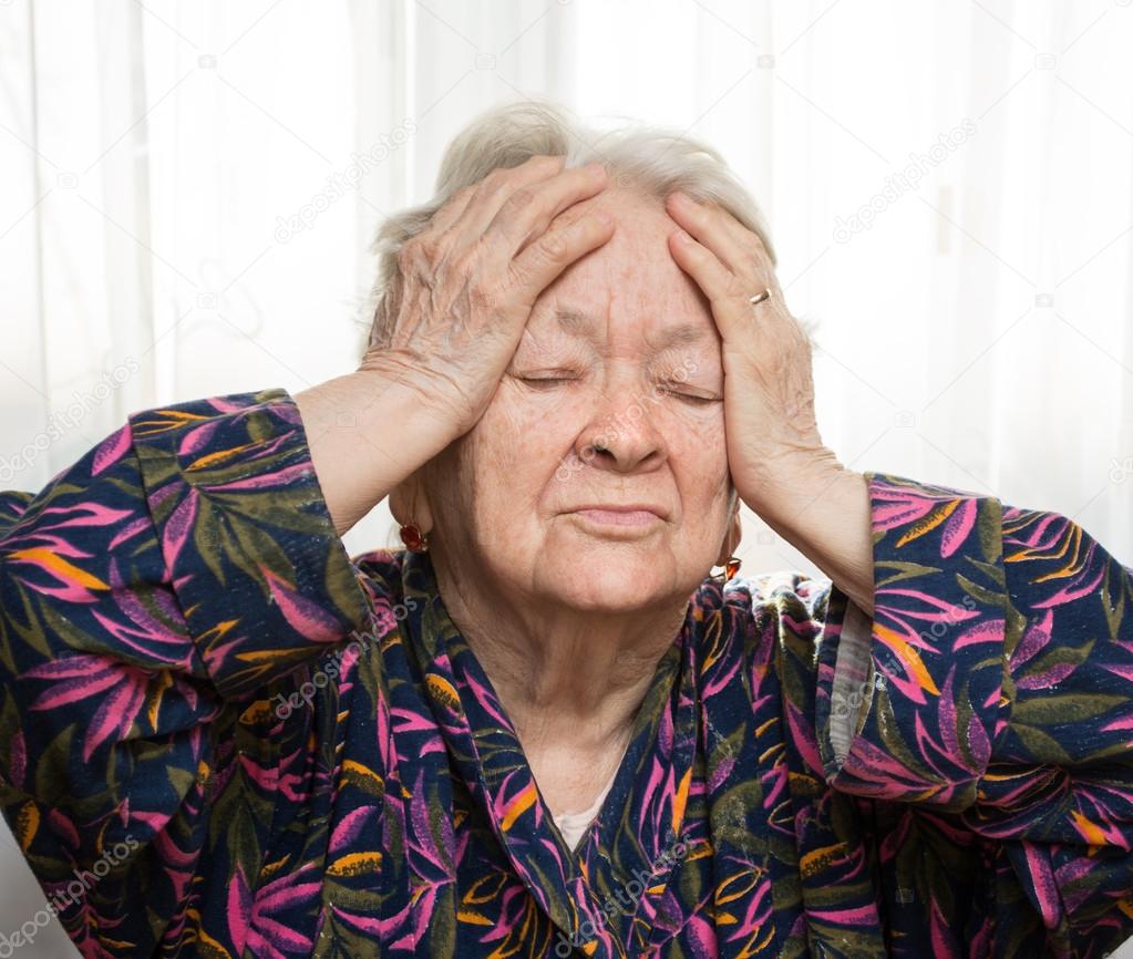 Senior woman suffering from headache