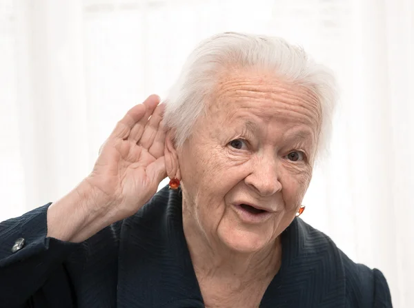 Portrait of old woman putting hand to her ear — Stock Photo, Image