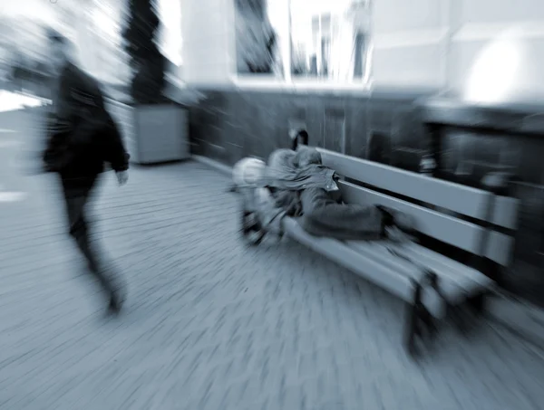 Beggar sleeping on a bench — Stock Photo, Image