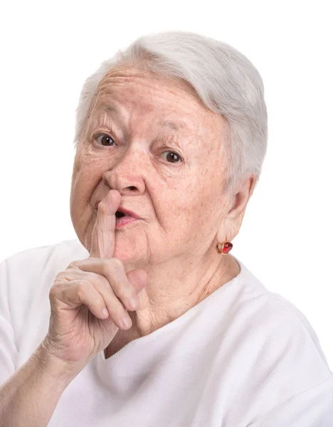 Stara kobieta z palcem na ustach, z prośbą o ciszy — Zdjęcie stockowe