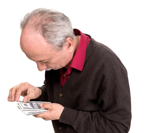 Old man looking at dollar bills — Stock Photo, Image