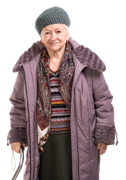 Old woman with a cane in outwear — Stock Photo, Image