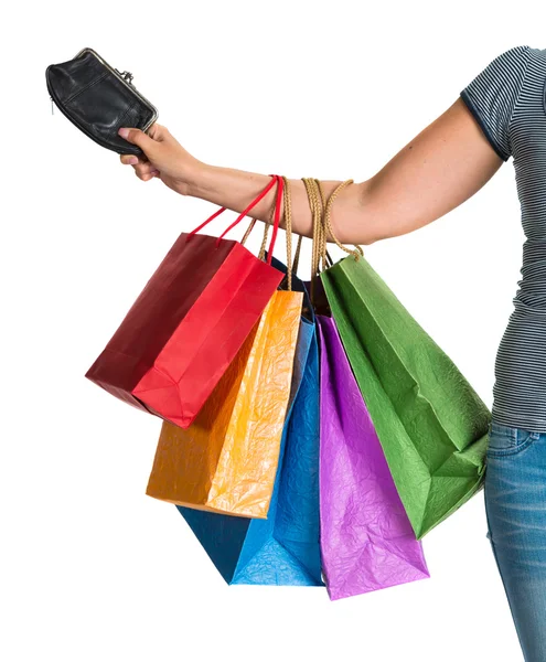 Mão feminina segurando sacos de compras e bolsa — Fotografia de Stock