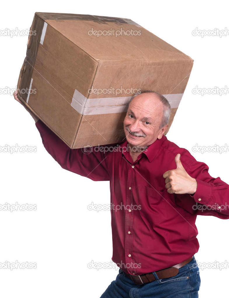 Senior man carries a heavy box