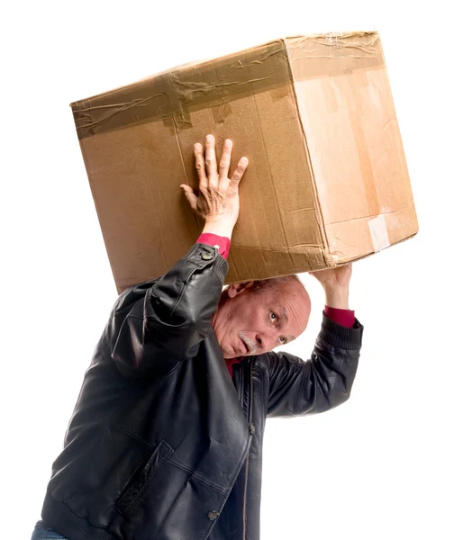 Senior man carries a heavy box — Stock Photo, Image