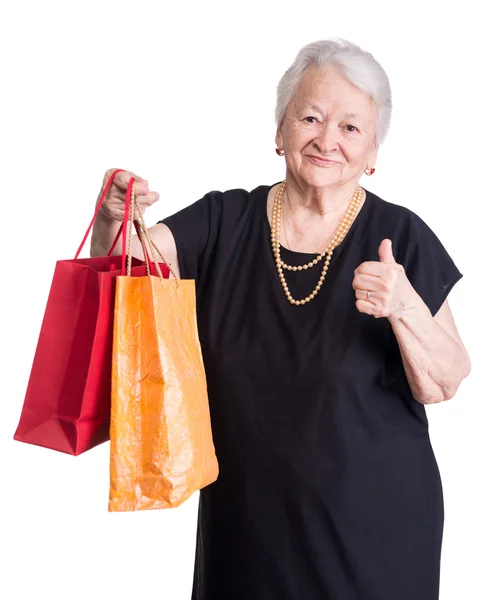 Happy old woman with shopping bags — Stock Photo, Image