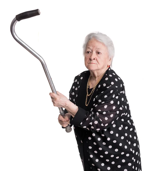 Old angry woman threatening with a cane — Stock Photo, Image