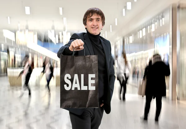 Smiling man n with shopping bag — Stock Photo, Image