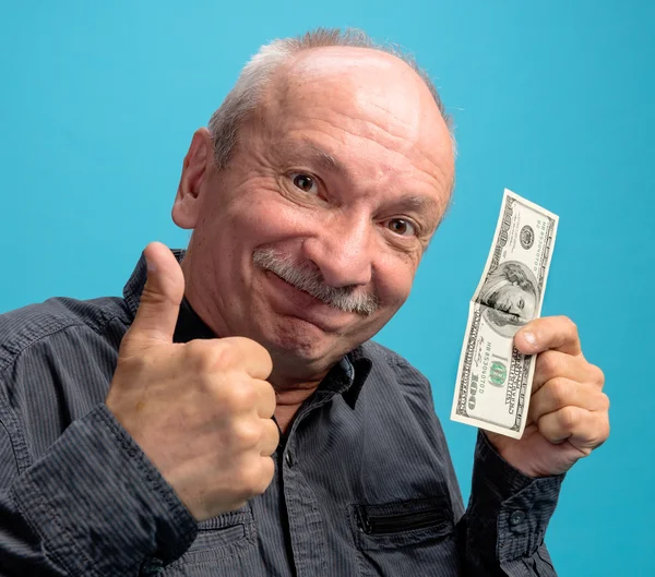 Viejo afortunado sosteniendo billetes de dólar —  Fotos de Stock