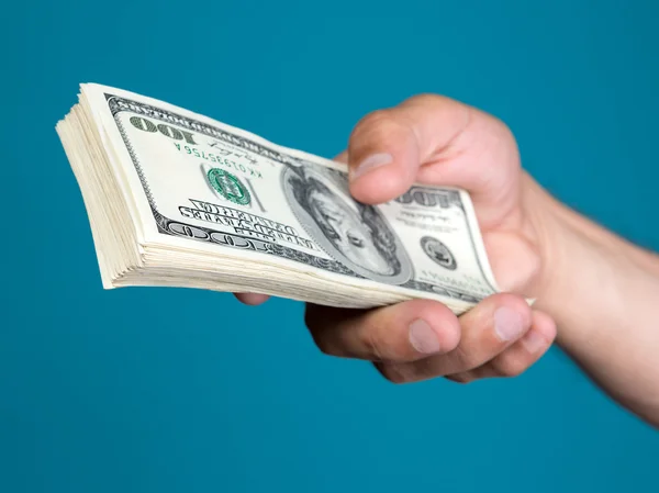 Man holding stack  of dollar bills — Stock Photo, Image