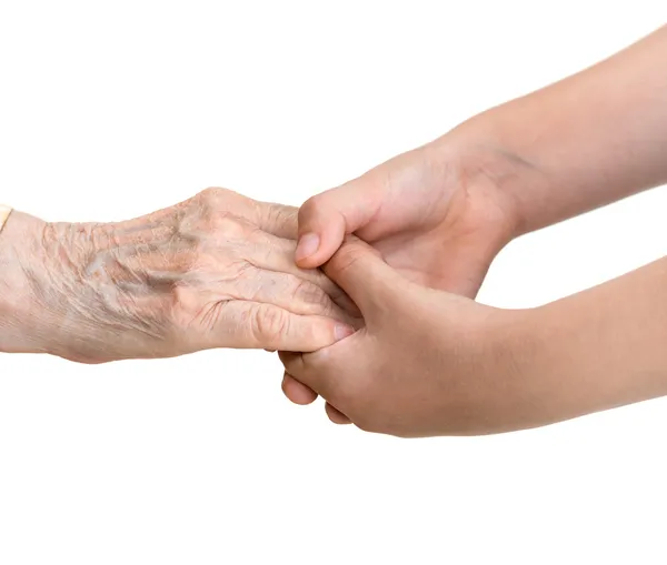 Oude vrouw en jonge meisje hand in hand — Stockfoto