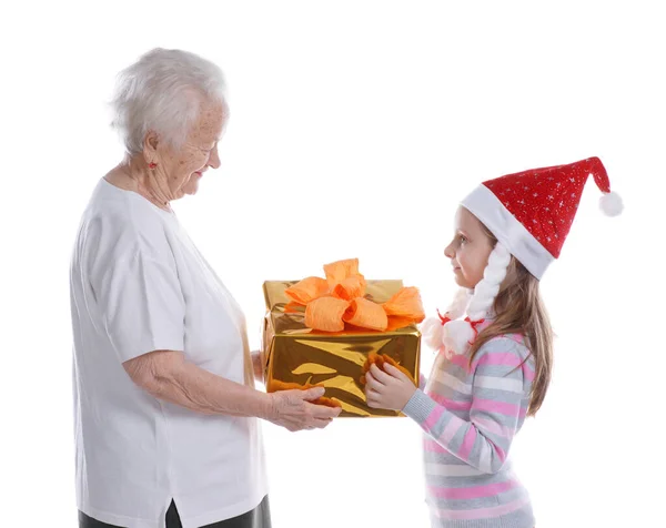 Senior Woman Presenting Gift Box Granddaughter Santa Hat Studio White — Stock Photo, Image