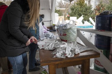 UZHOROD, UKRAINE - 1 Mart 2022 Rusya 'nın Ukrayna' ya karşı savaşı. Molotof kokteylleri için malzeme üreten gönüllüler