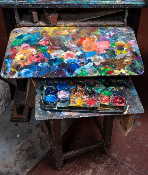 Artistic  paints and palette in art workshop