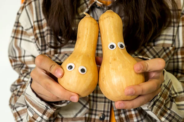 Les mains des filles tiennent citrouilles avec les yeux Saison d'automne — Photo