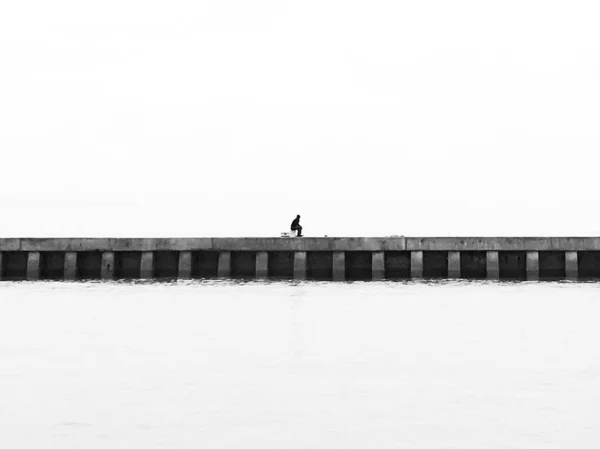 Silhouette Lonely Man Sits Concrete Dam Sea Fishing Processed Monochrome — Stock Photo, Image