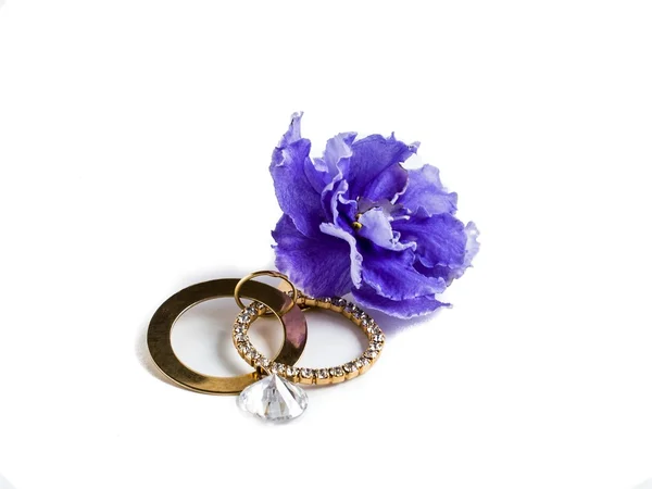Jewelry and blue flower saintpaulia — Stock Photo, Image