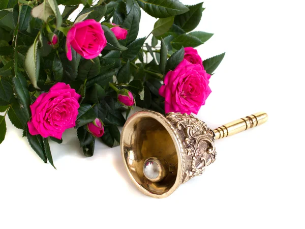 Antique bronze bell and bouquet of roses — Stock Photo, Image