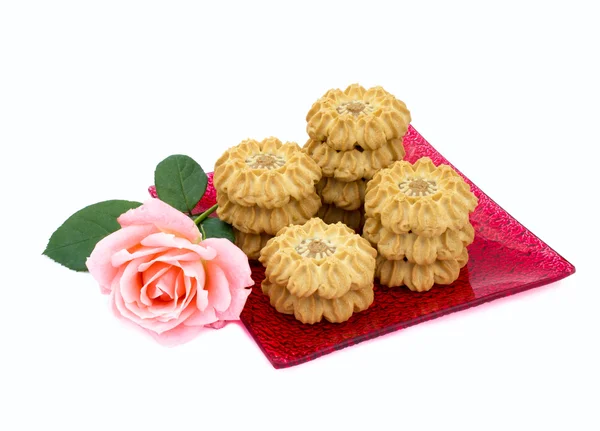 Cookies figure is a square plate with a rose — Stock Photo, Image