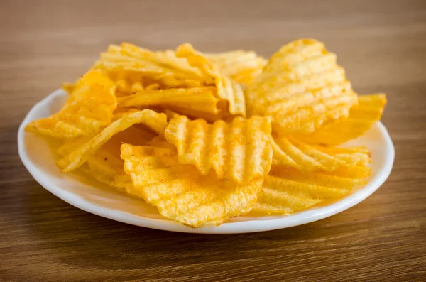 Chips are in white plate — Stock Fotó