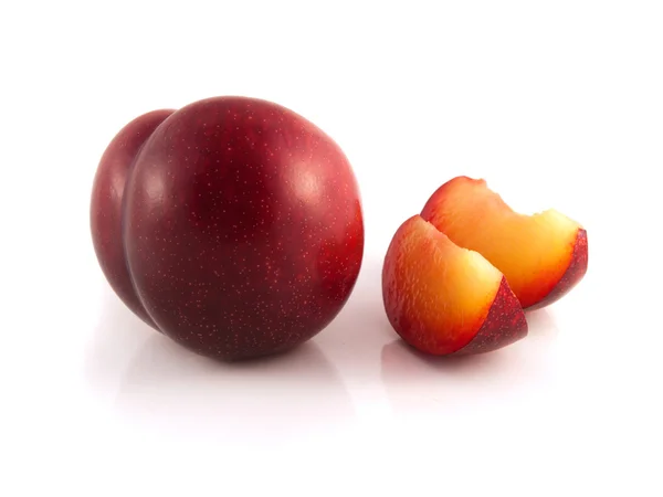 Ameixa madura vermelha isolada com duas fatias . — Fotografia de Stock